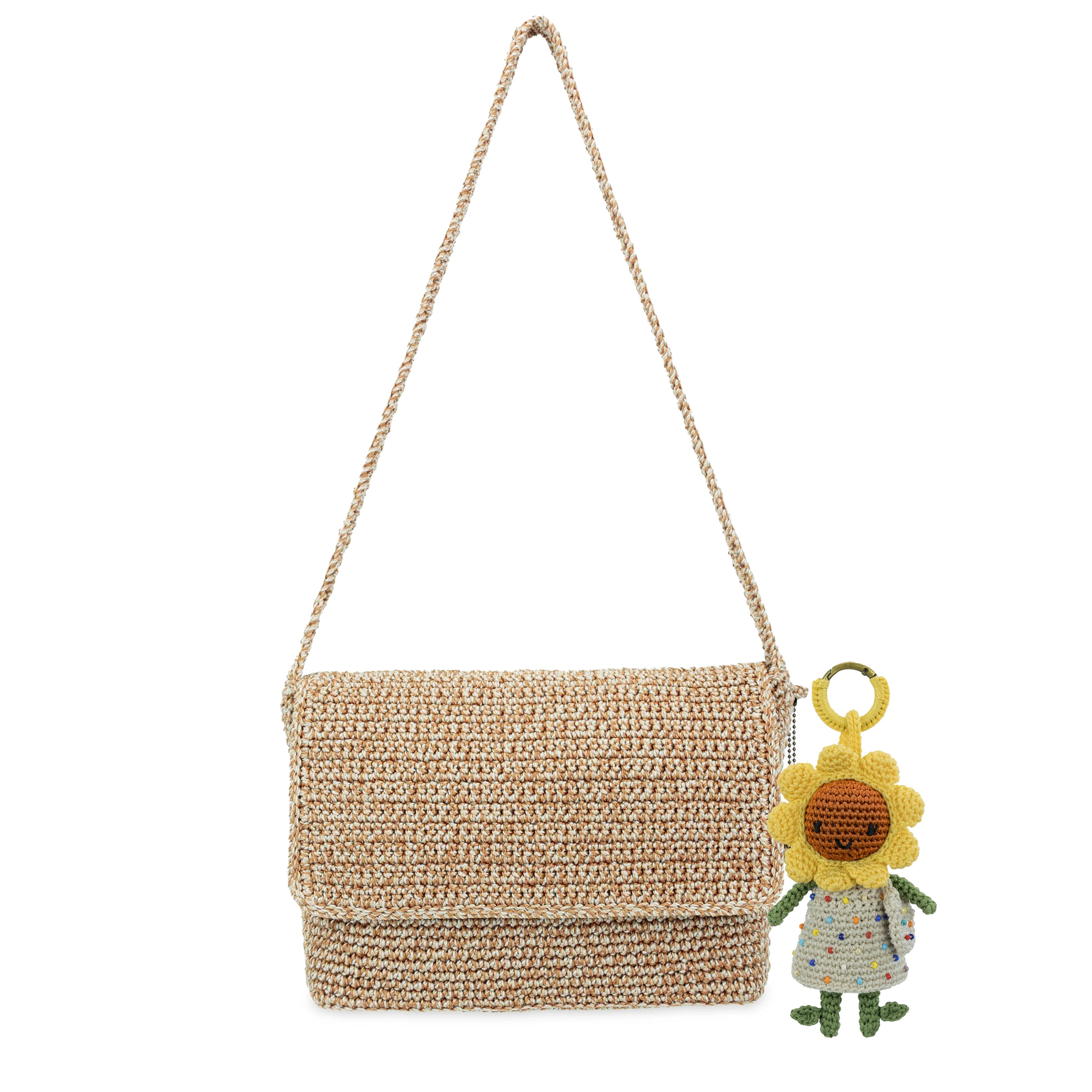 Tan woven shoulder bag with chain strap and yellow sunflower-shaped dangle charm attached.